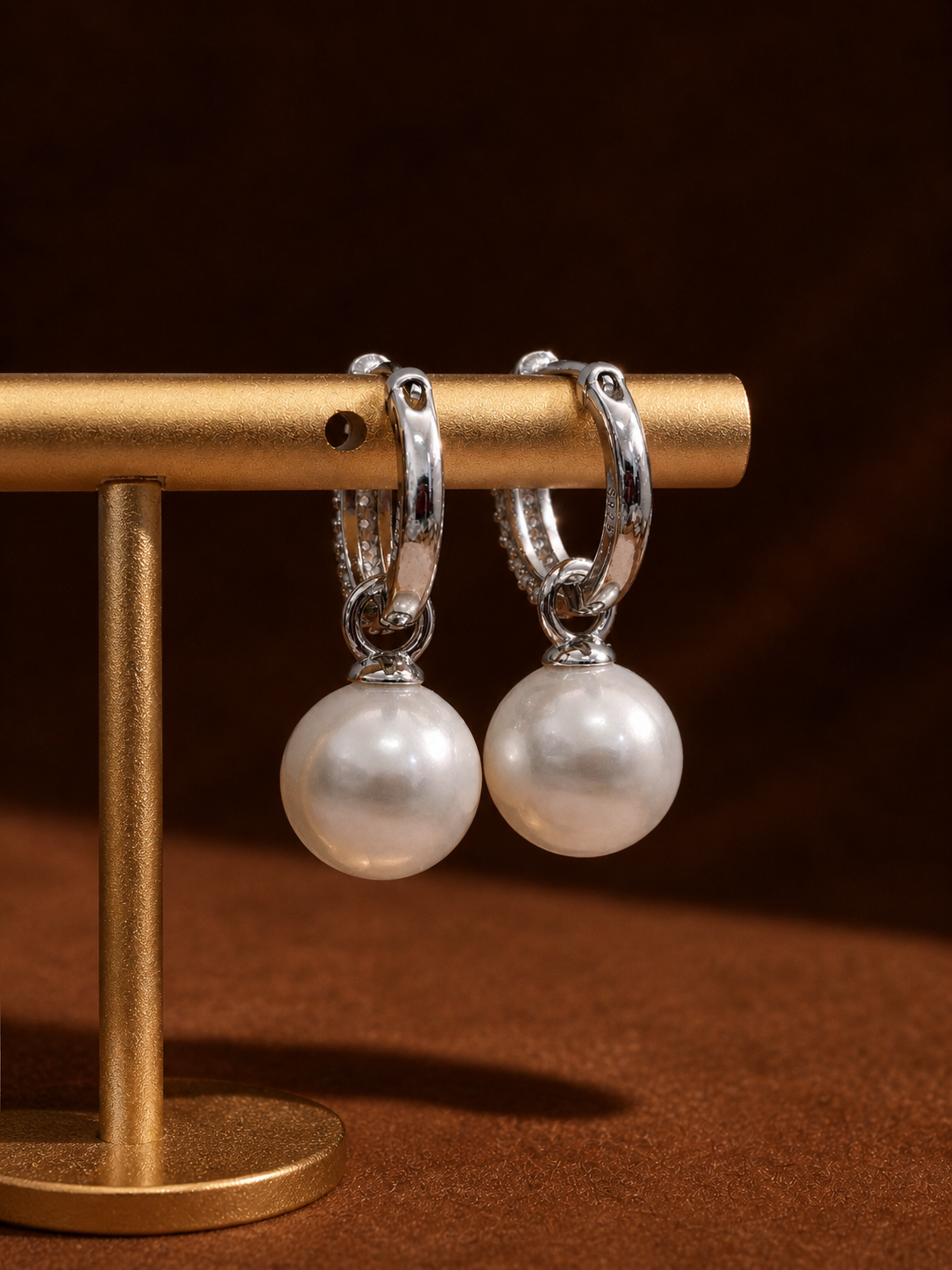 Silver hoop lock earrings with round white pearls on glittering hinged hoops