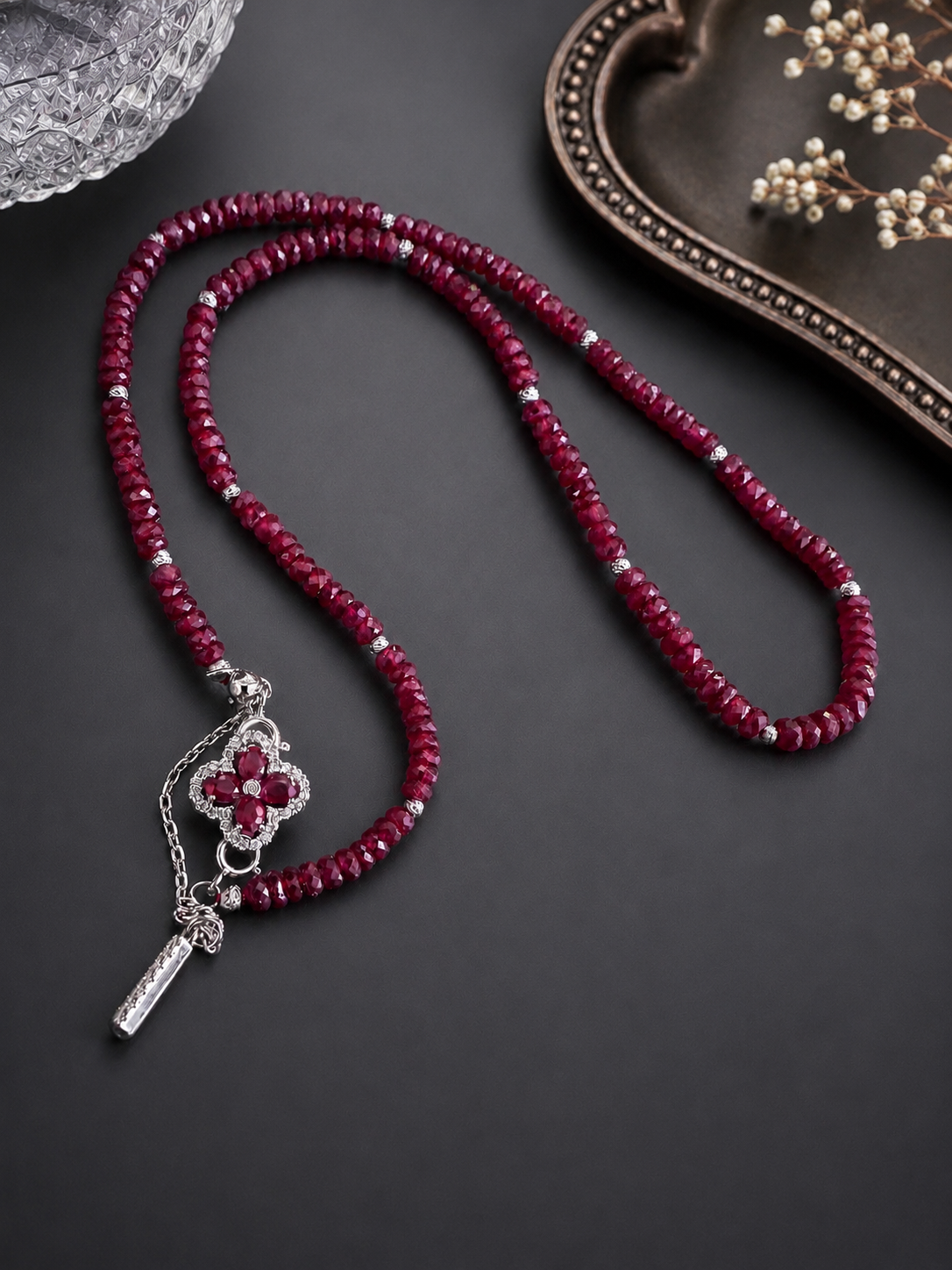 Ruby clover pendant with key charm on braided burgundy cord necklace