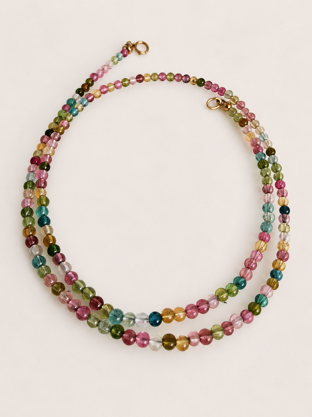 Rainbow beaded necklace with multicolor stones and gold clasp at top