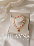 Keshi pearl necklace with red ruby accents and gold pendant, shown in gift box