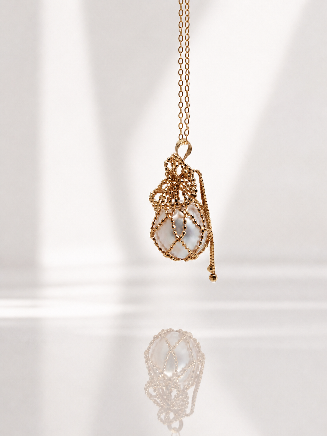 18K solid gold net pouch pendant on gold chain with small dangling charm