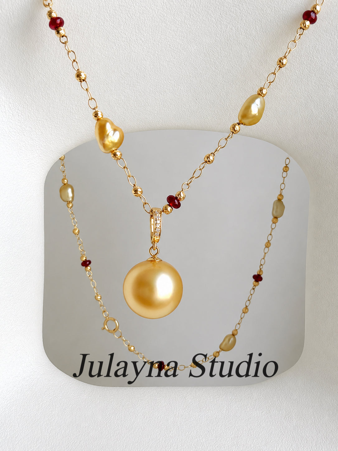 18K gold pearl pendant necklace with red bead accents on a delicate chain