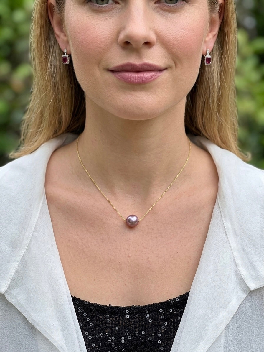 Gold necklace featuring a purple round pearl pendant