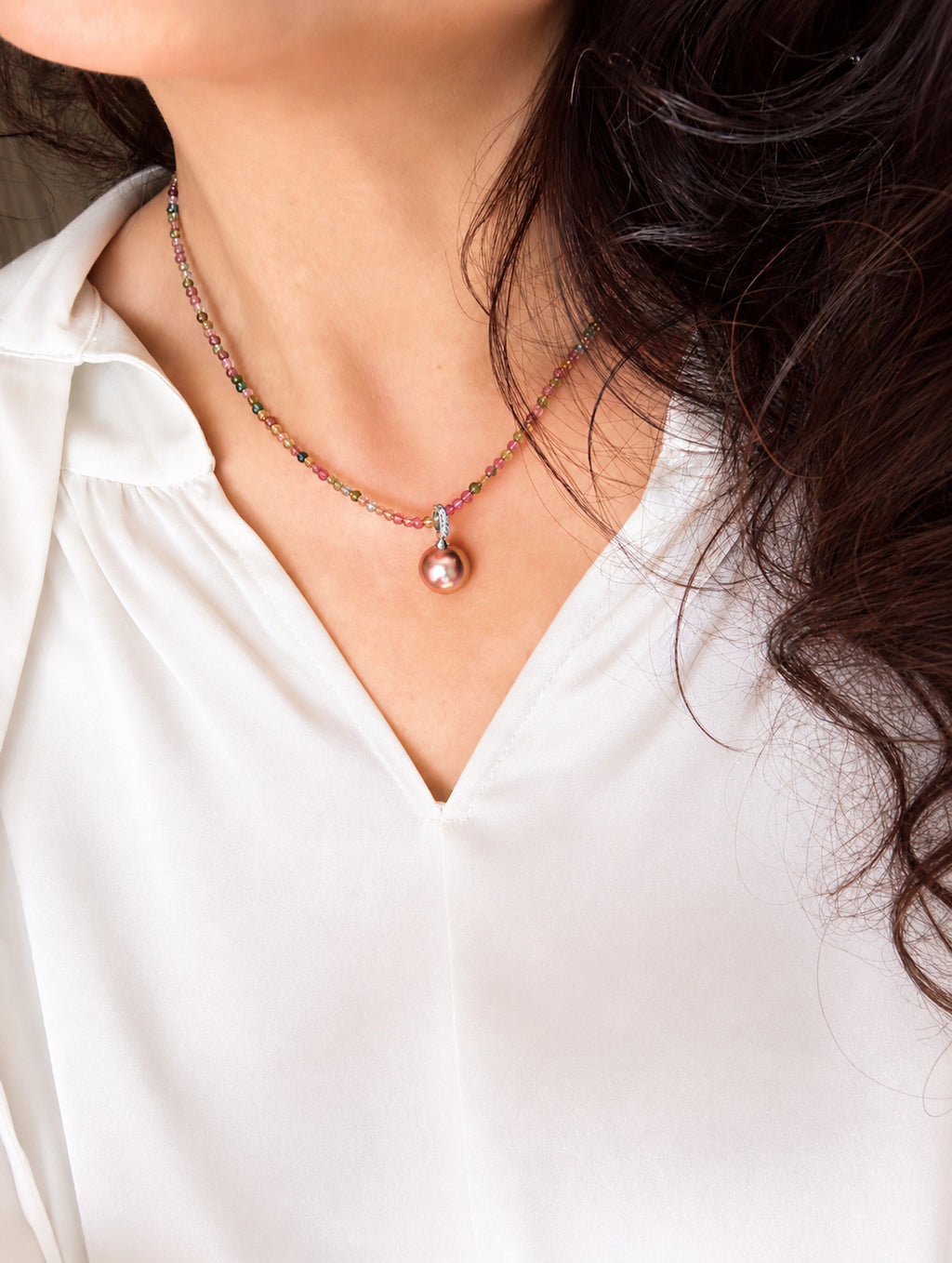 Rainbow beaded necklace with small round multicolor beads and a pink pearl drop