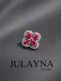 Sterling silver ruby clover pendant with four round pink-red gemstones in a halo setting