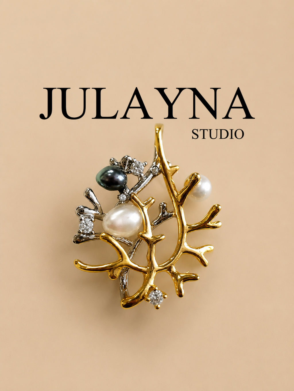 Pendant charm with pearl, dark bead, and rhinestone details on a gold-tone branch setting