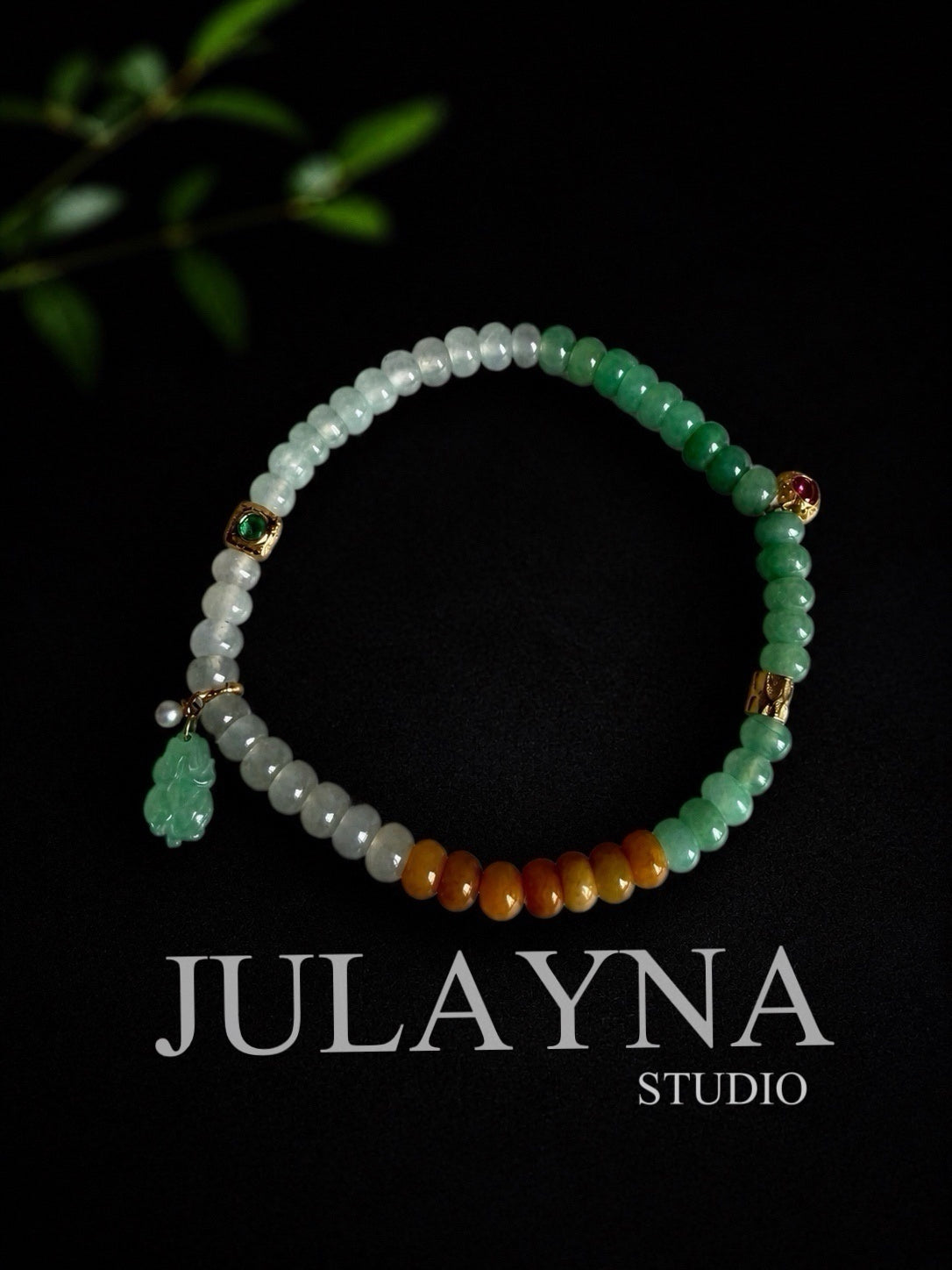 Jadeite beaded bracelet with green and white beads, gold charms, and small red accents