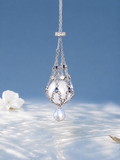 Pendant necklace with openwork silver-toned frame, blue accents, and a large teardrop pearl