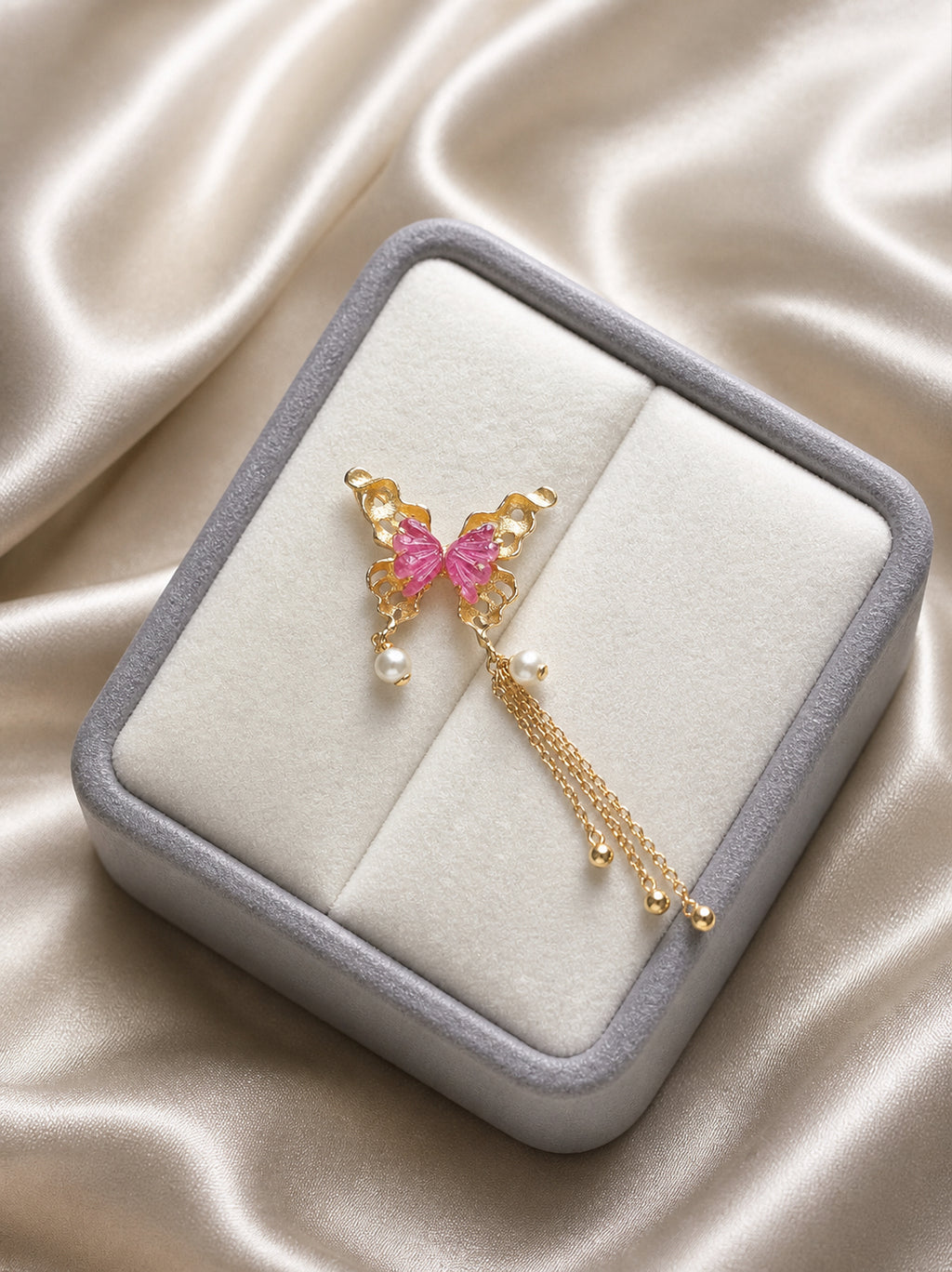 Butterfly pendant with pink tourmaline and pearl drop tassel on jewelry box insert