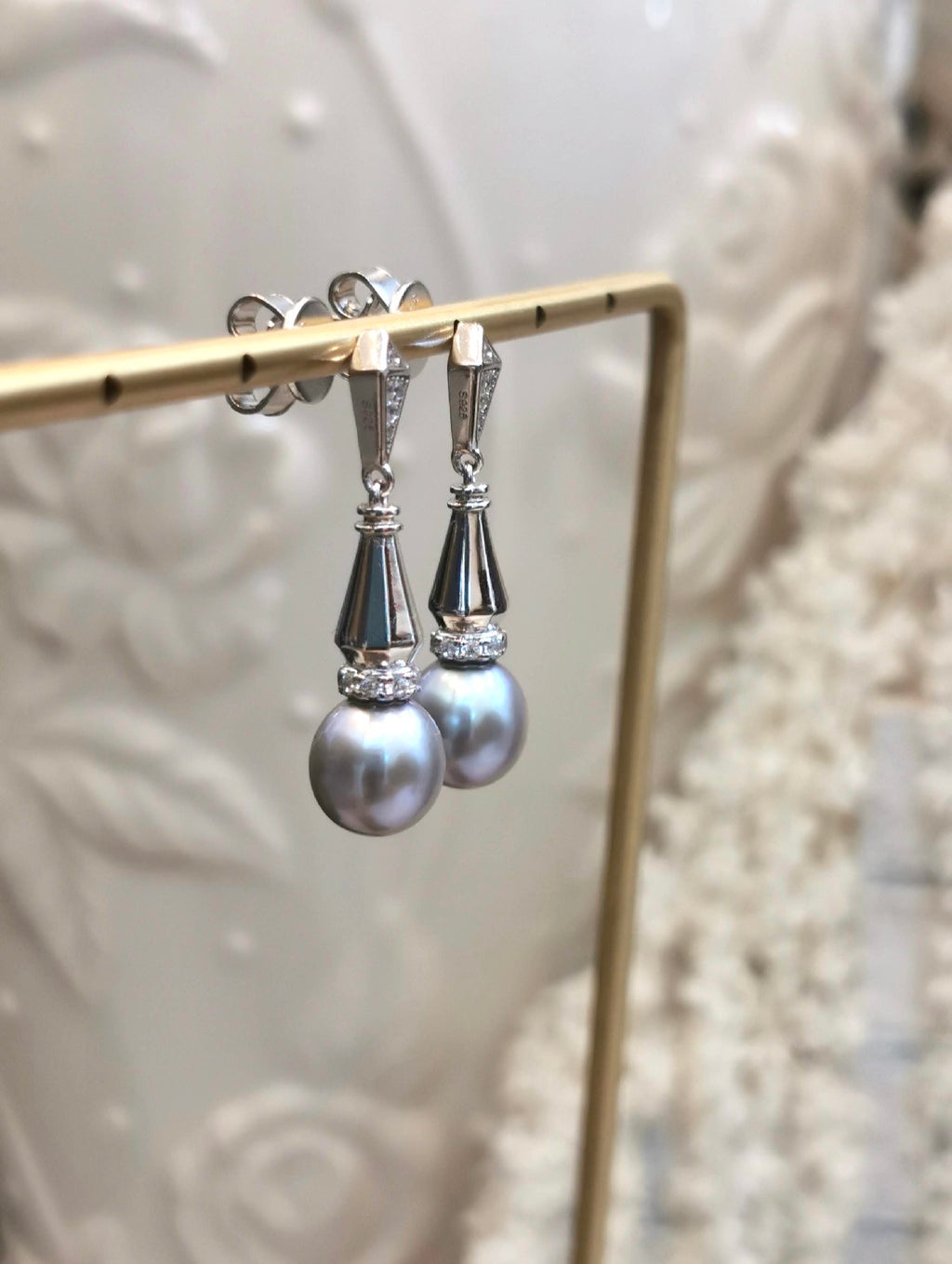 Silver-tone dangle earrings with gray teardrop pearls and sparkling geometric drops