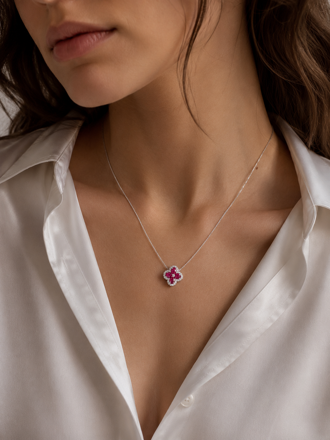 Four-leaf clover gemstone pendant on a thin silver chain necklace