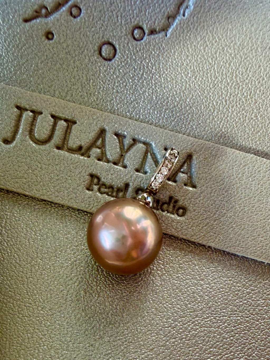 Round pearl drop pendant with rhinestone top and gold-toned hanging loop