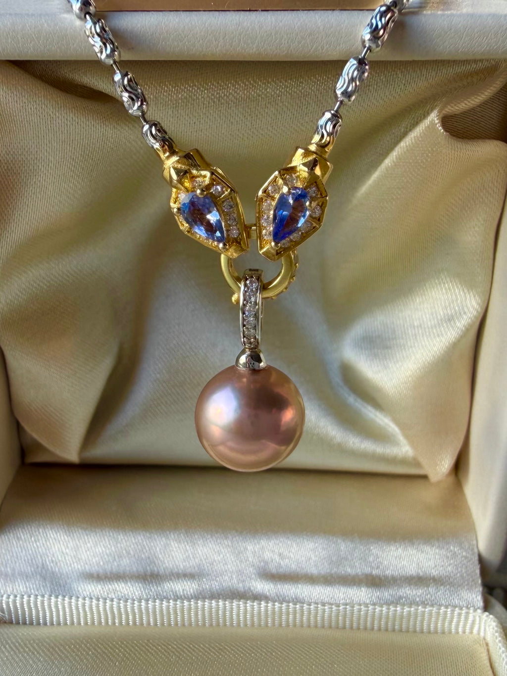 Rainbow tourmaline necklace featuring blue teardrop charms and rose-pink pearl