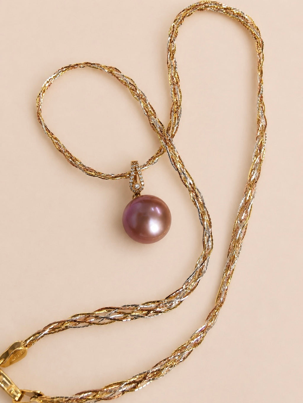 Gold pearl pendant necklace with purple pearl drop and diamond accents on chain