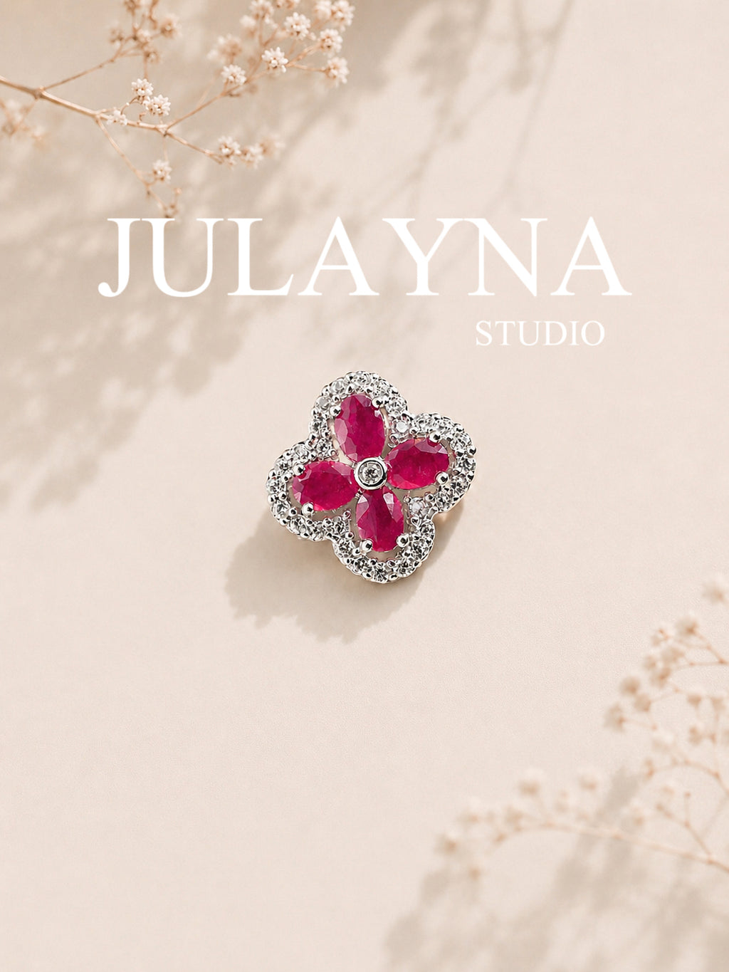 Sterling silver clover pendant with three ruby-like stones and clear stone halo