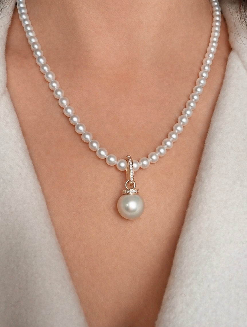 White bead necklace with gold South Sea pearl pendant and gemstone bail