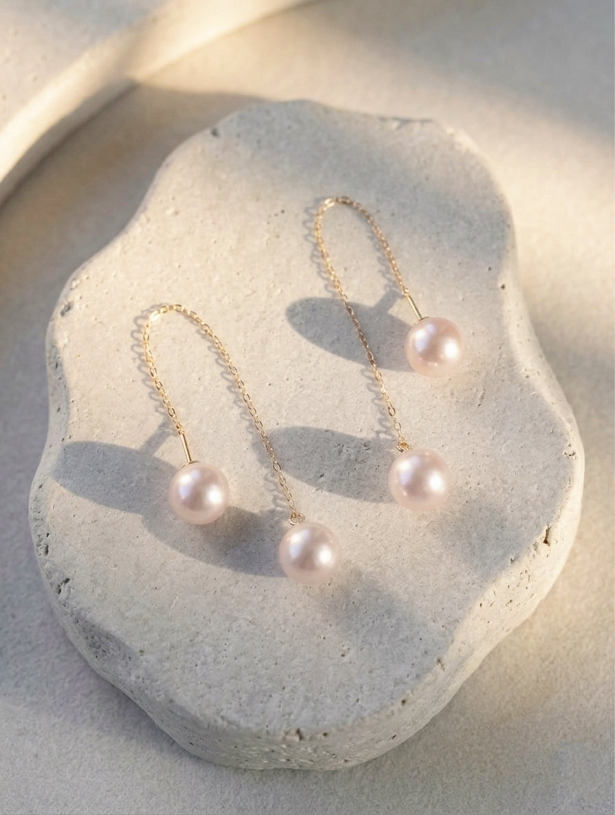 Long threader pearl earrings with gold-tone chains and two dangling pearls