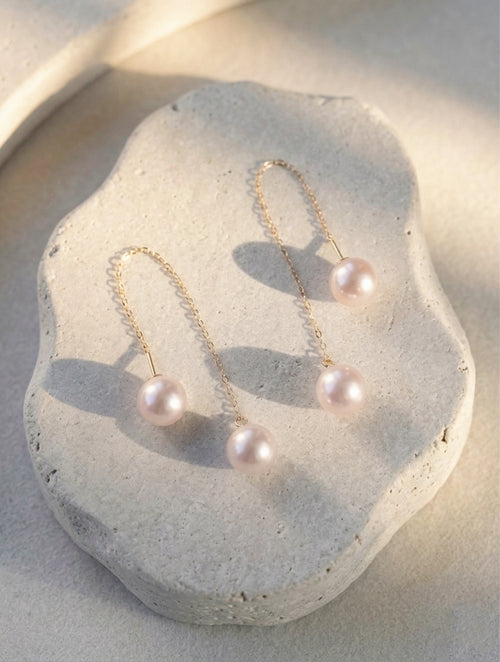 Long threader pearl earrings with gold-tone chains and two dangling pearls