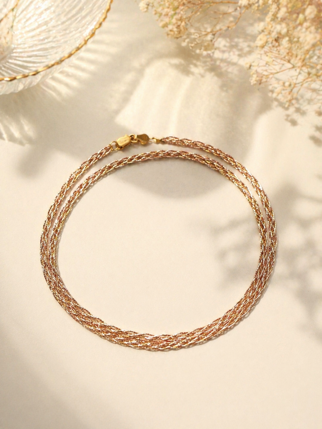 Three-tone gold braided necklace with S925 chain, flat lay close-up