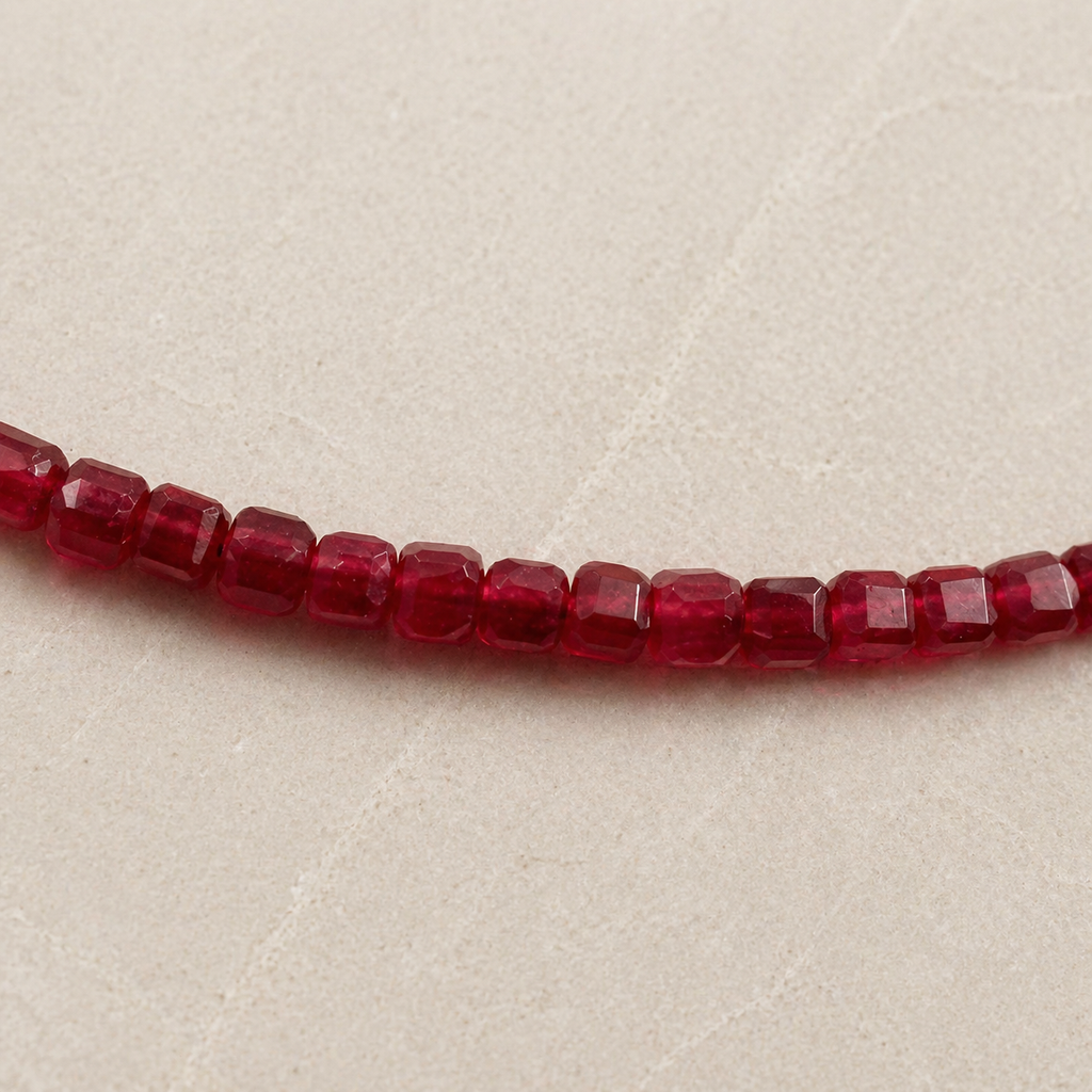 Close-up of ruby square-cut bead strand necklace with faceted beads