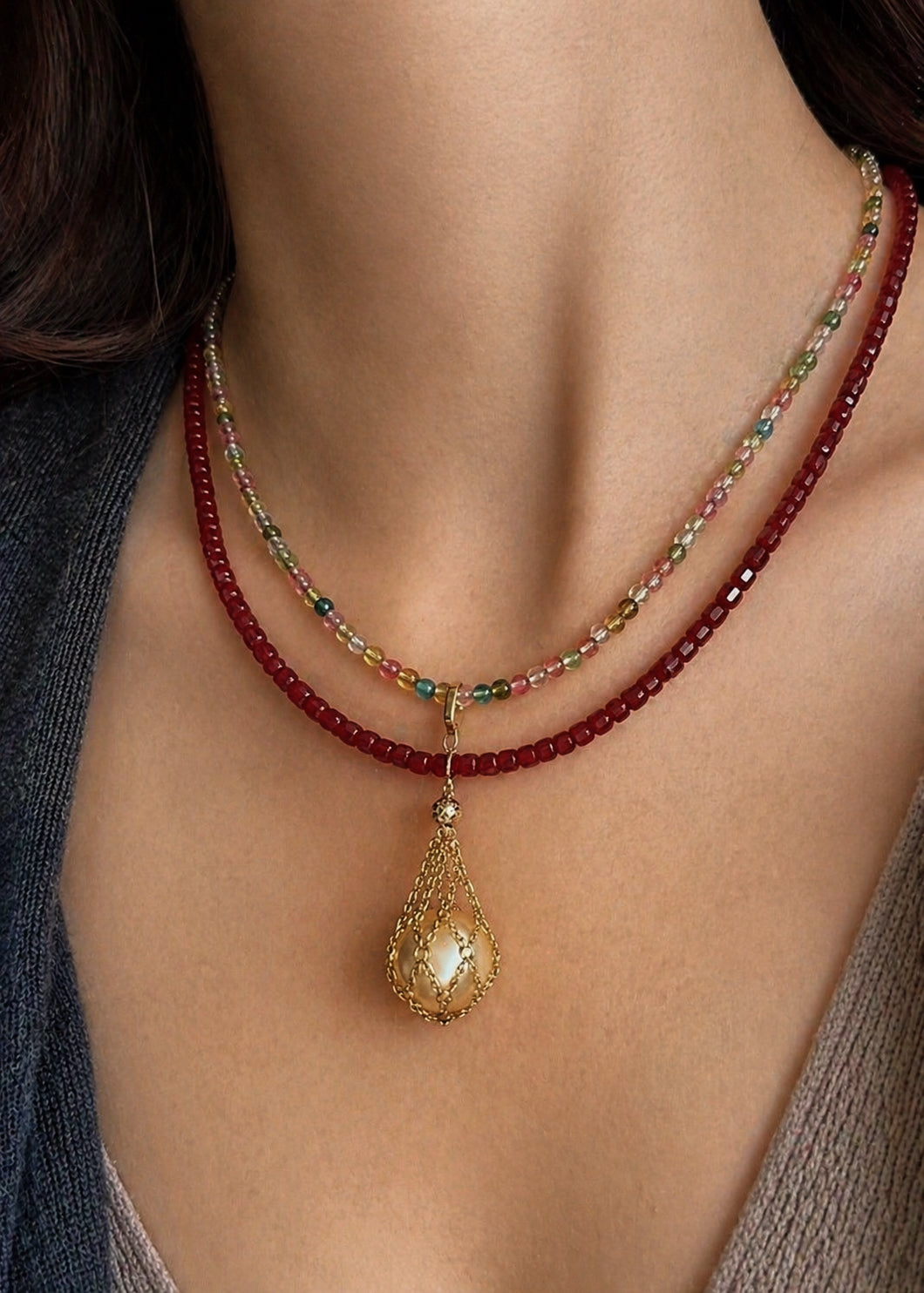 Multistrand bead necklace with gold teardrop net pearl pendant