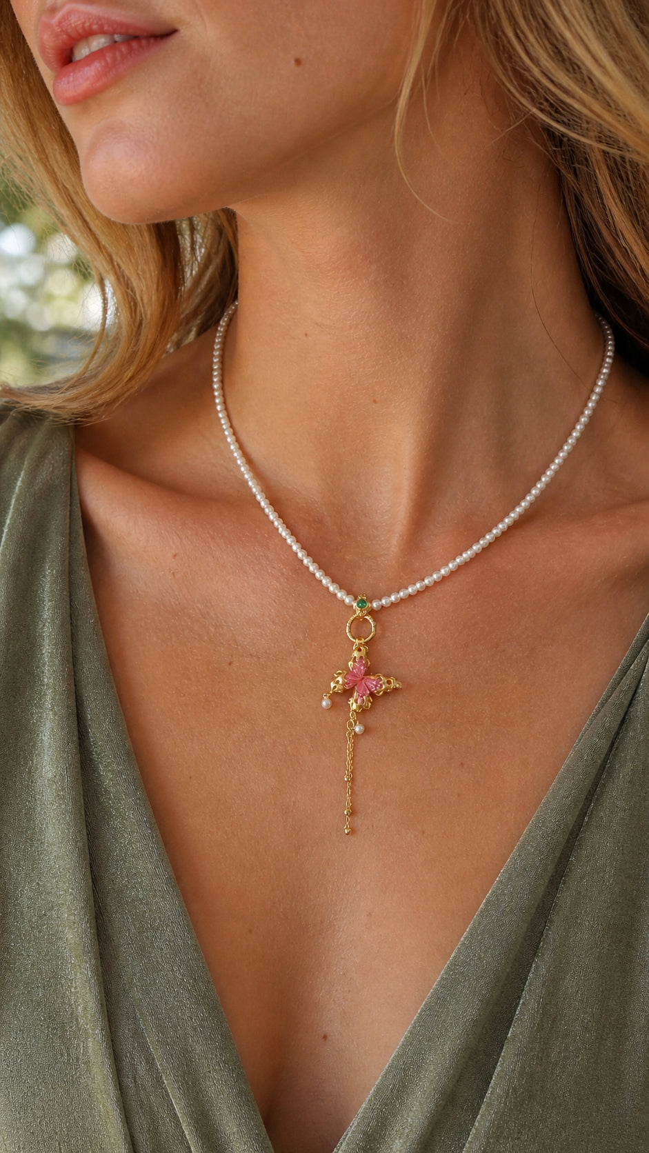 Gold butterfly tourmaline pendant with pearl tassel on a delicate chain at neckline