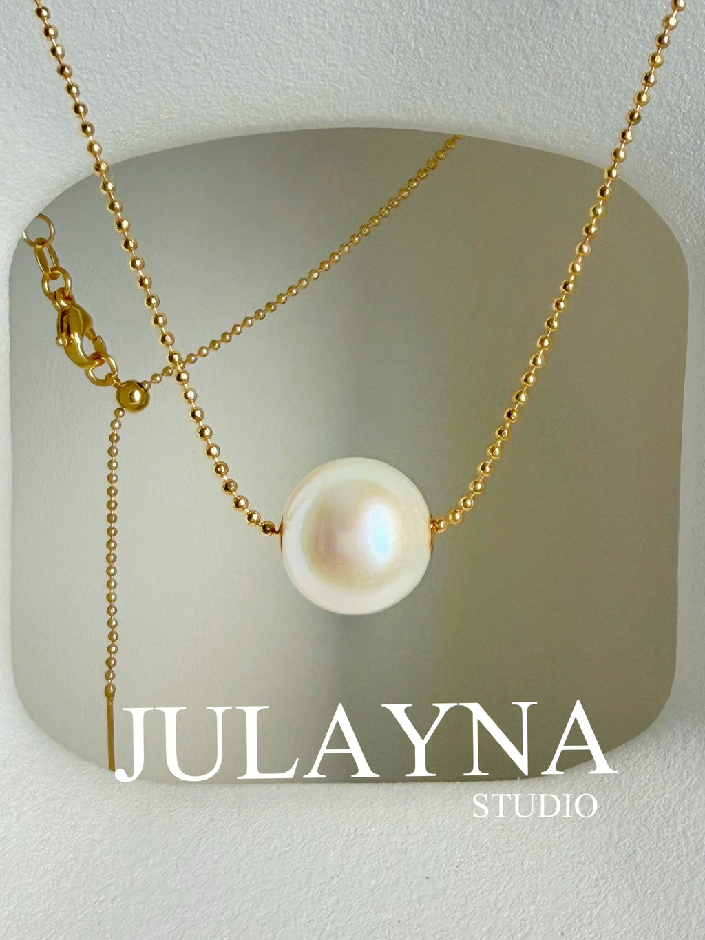 Gold-tone chain necklace with large white freshwater pearl pendant