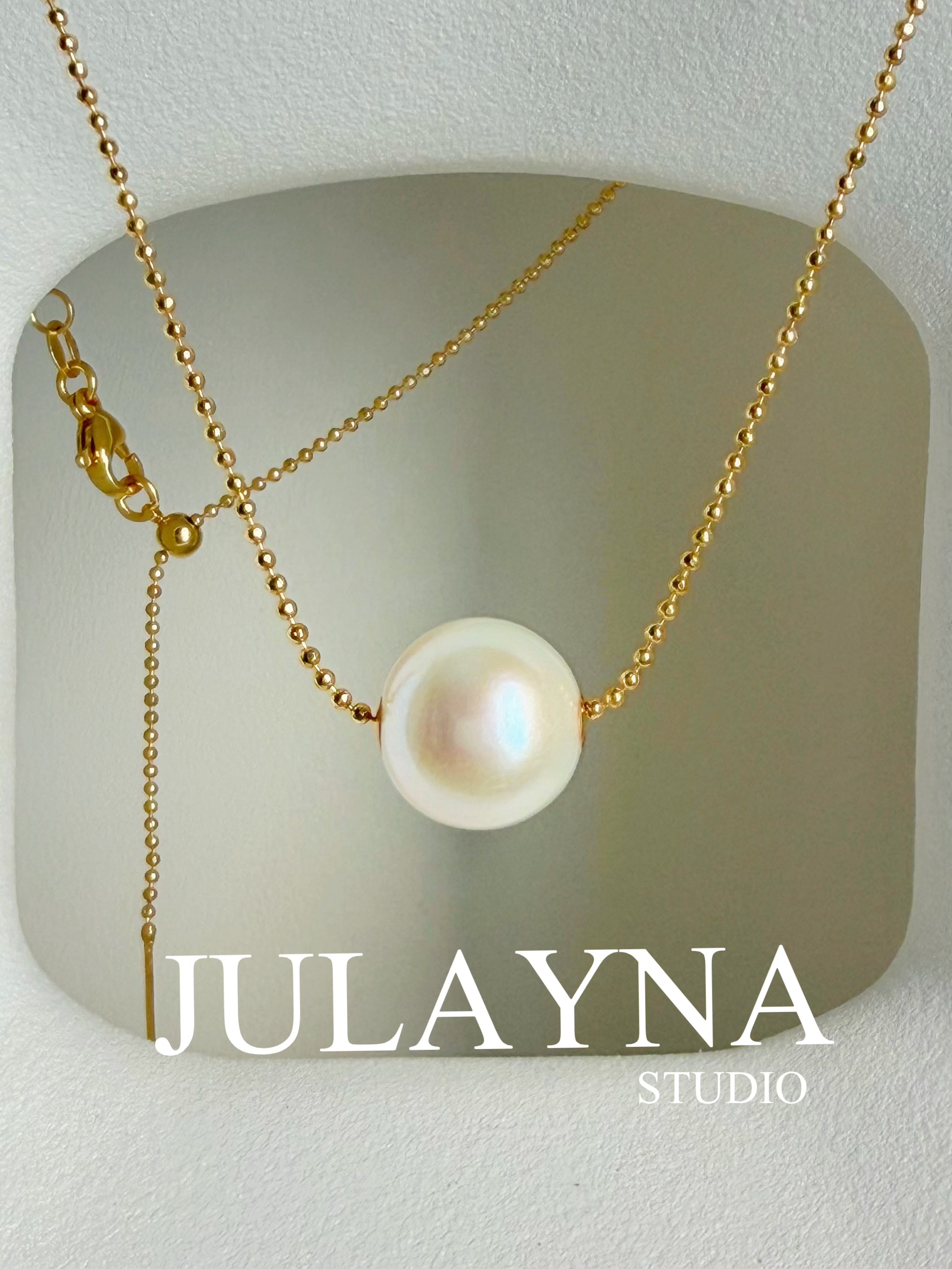 Gold-tone chain necklace with large white freshwater pearl pendant