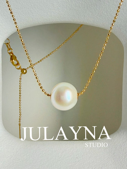 Gold-tone chain necklace with large white freshwater pearl pendant