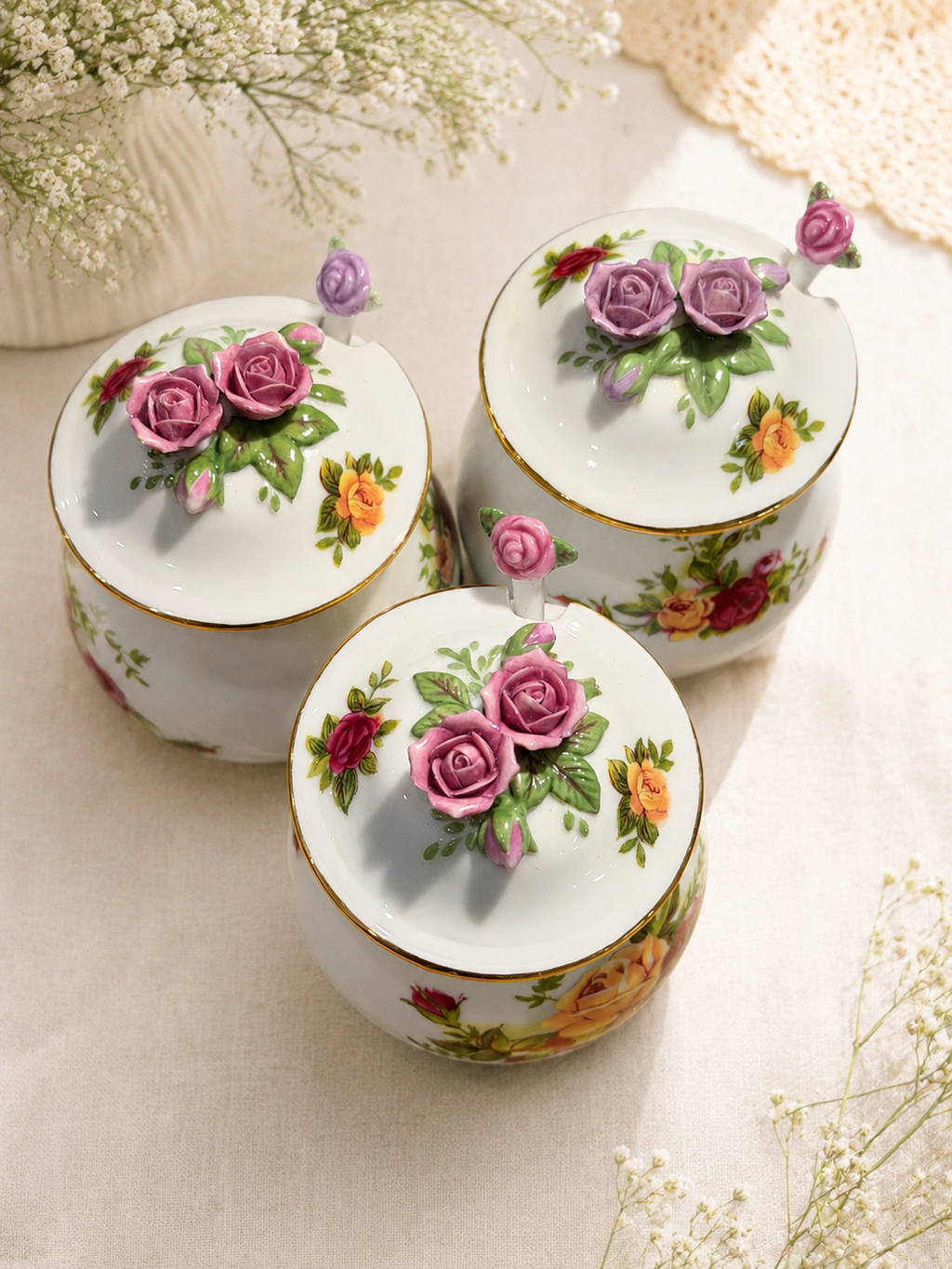 Porcelain sugar and salt jars with rose floral lids on a neutral table setting