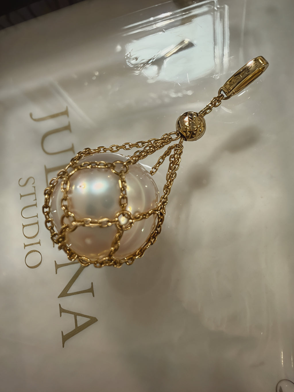 18k gold net pendant with saltwater pearl on a delicate chain
