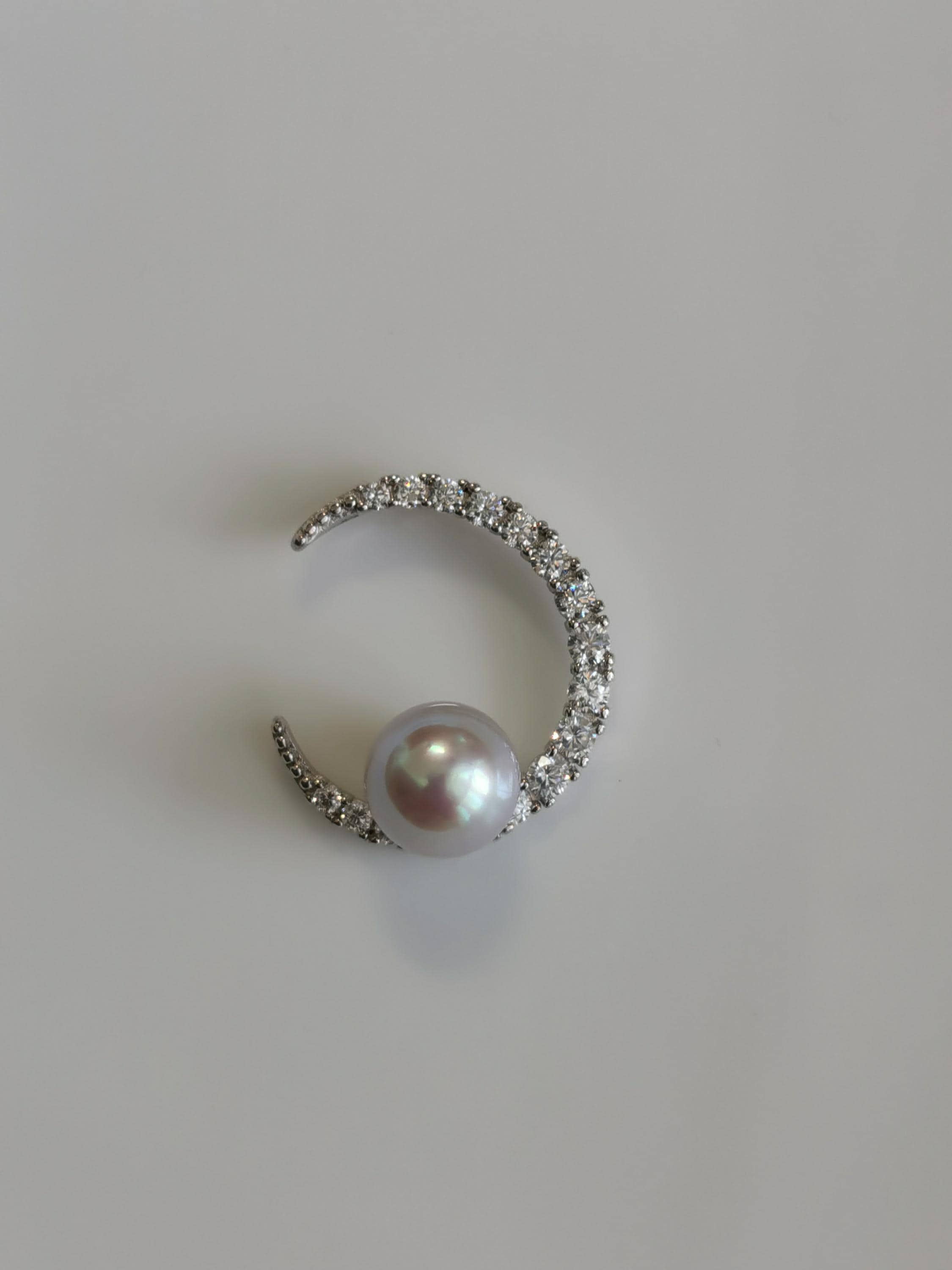 Silver crescent pearl pendant with pavé stones and round cultured pearl centerpiece