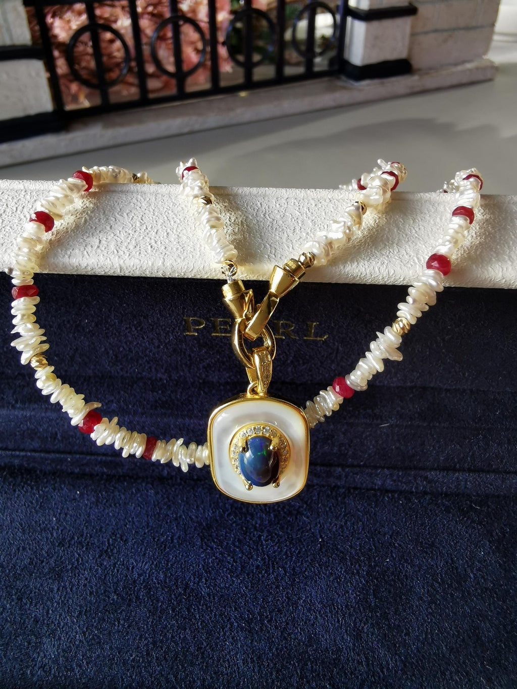 Pearl and red-bead necklace with blue opal-style pendant, gold-tone clasp