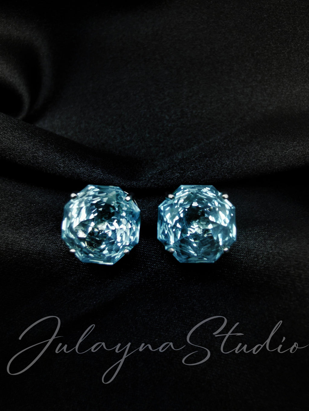 Blue topaz stud earrings, faceted circular stones on posts with dark backing