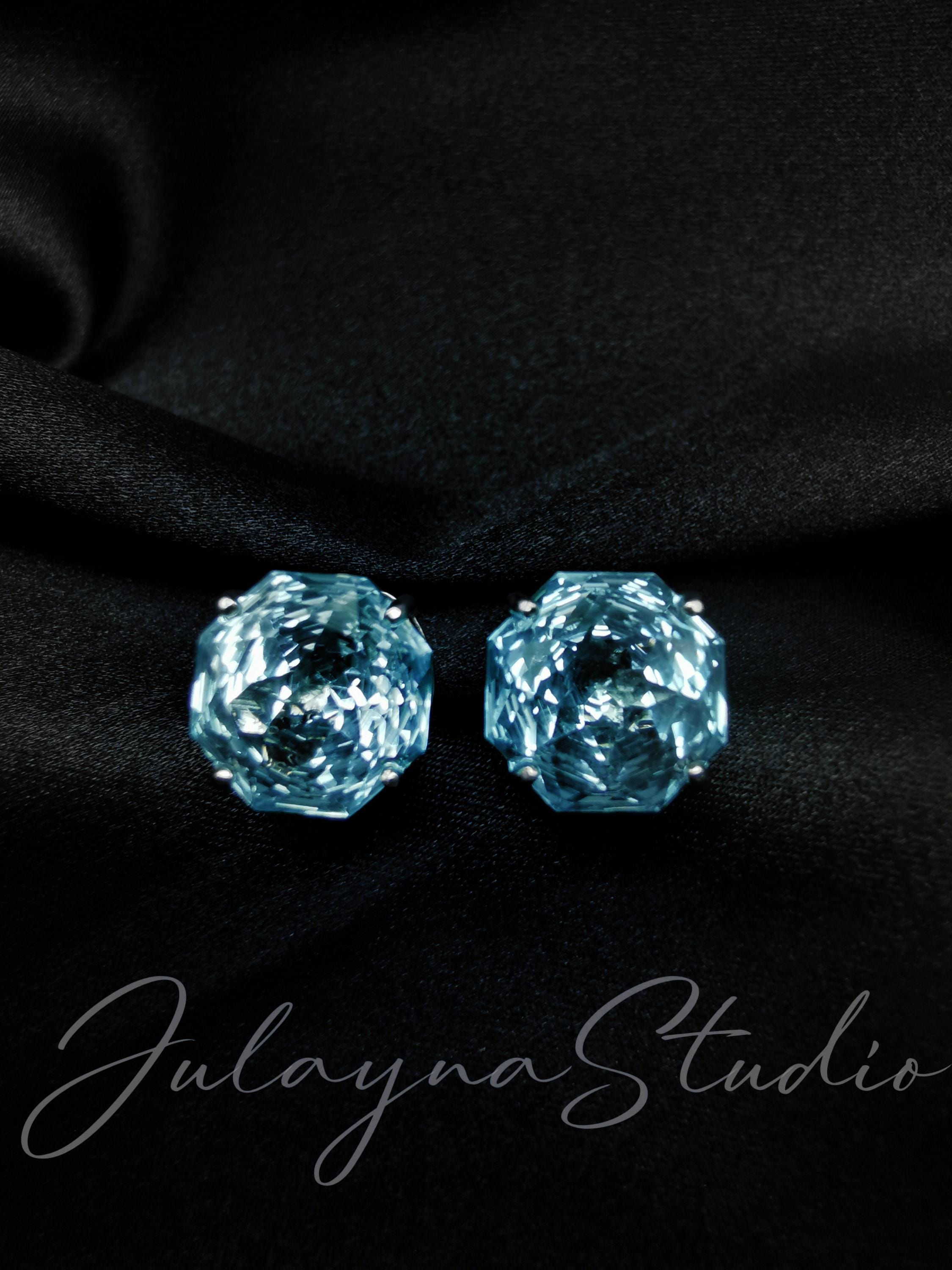 Blue topaz stud earrings, faceted circular stones on posts with dark backing