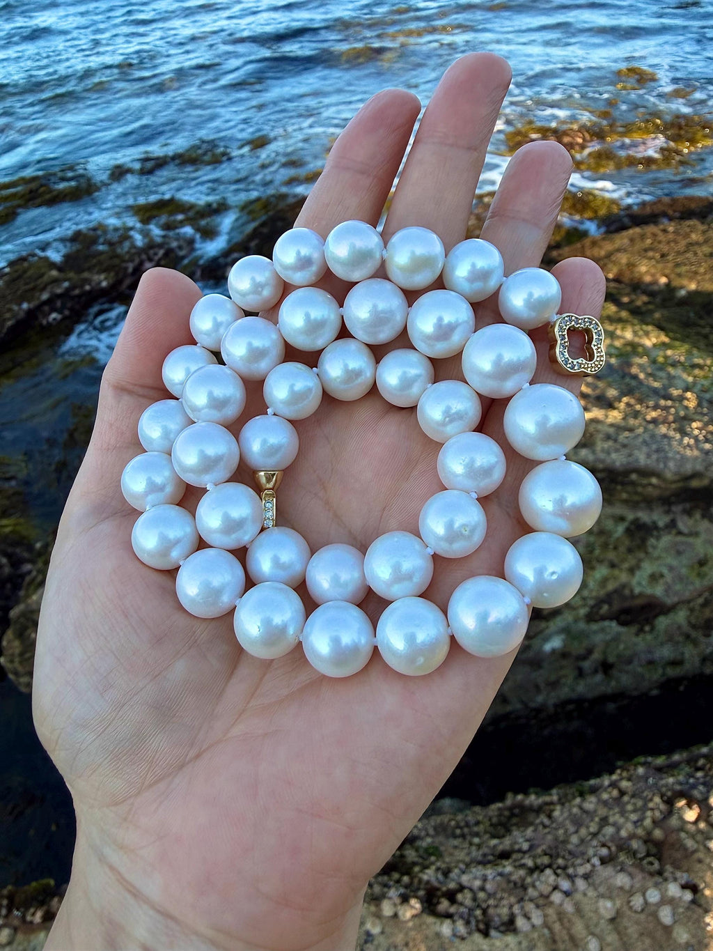 Light blue pearl necklace with round beads and gold-tone clasp detail