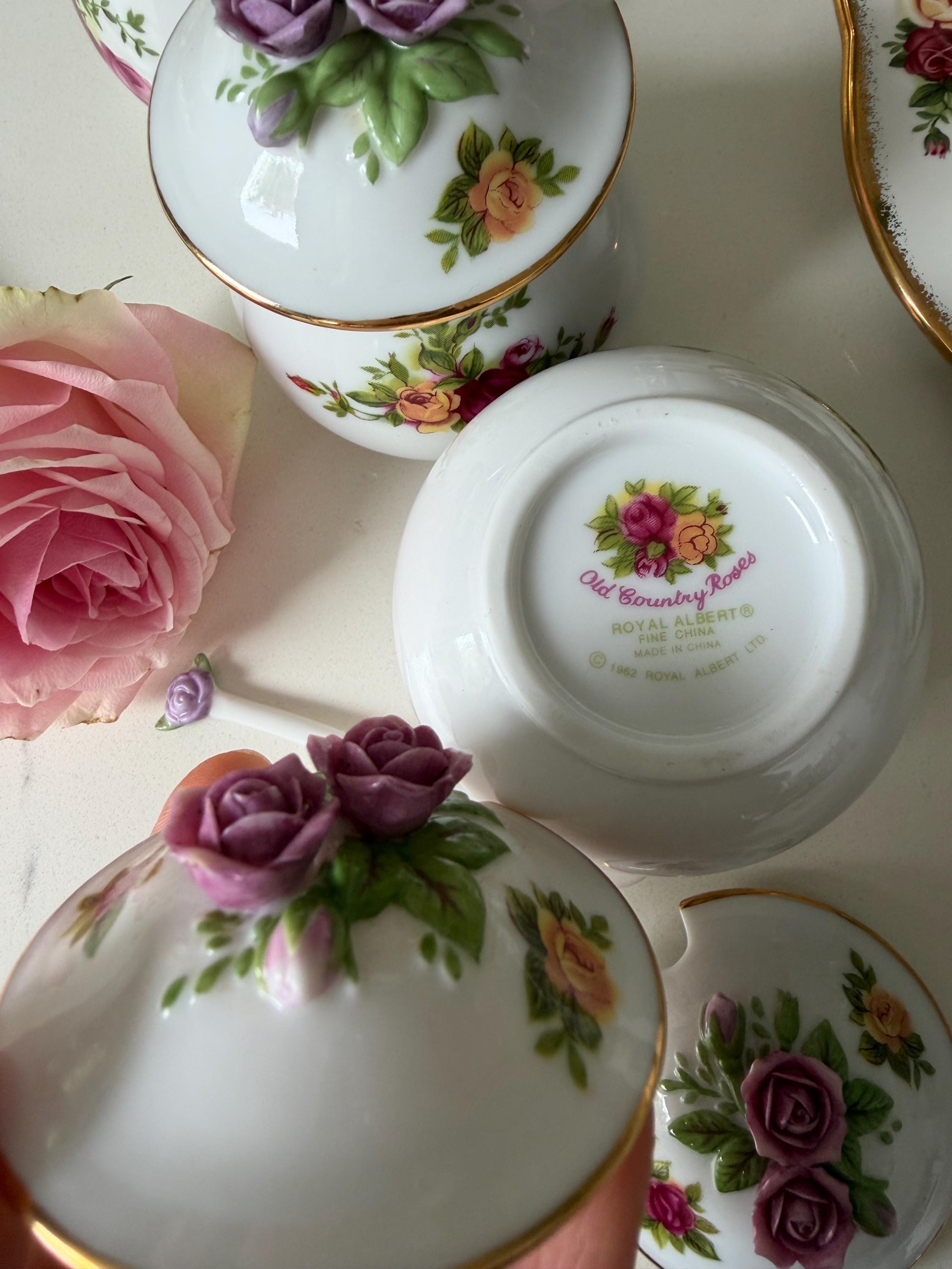 Porcelain jar lids and bases with rose floral detailing and decorative underside print