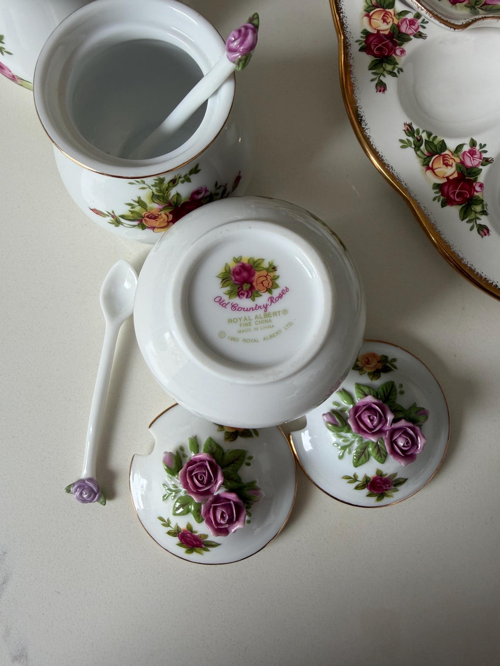 Lidded porcelain sugar and salt jars with floral rose accents and purple knob tops