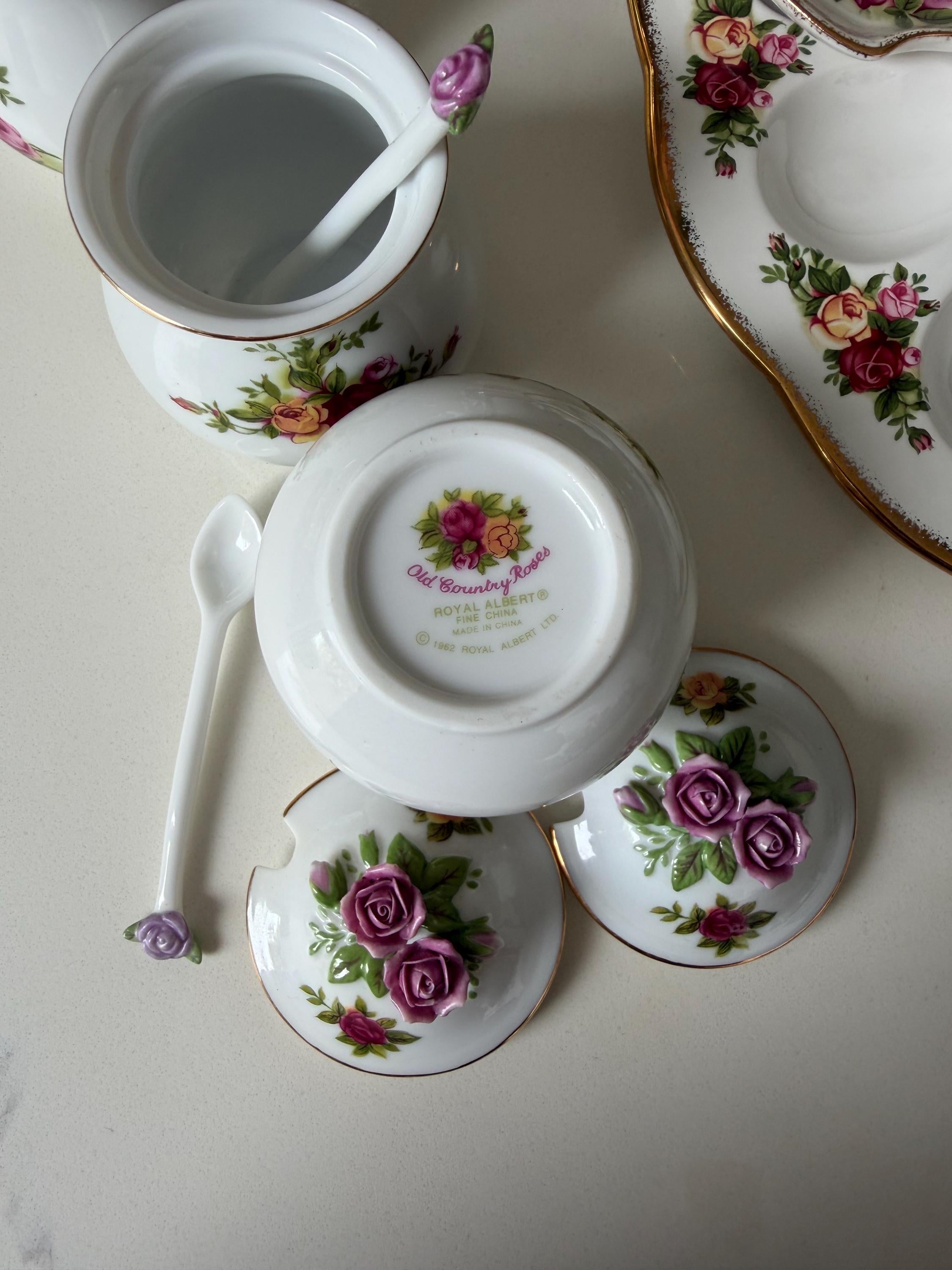 Lidded porcelain sugar and salt jars with floral rose accents and purple knob tops