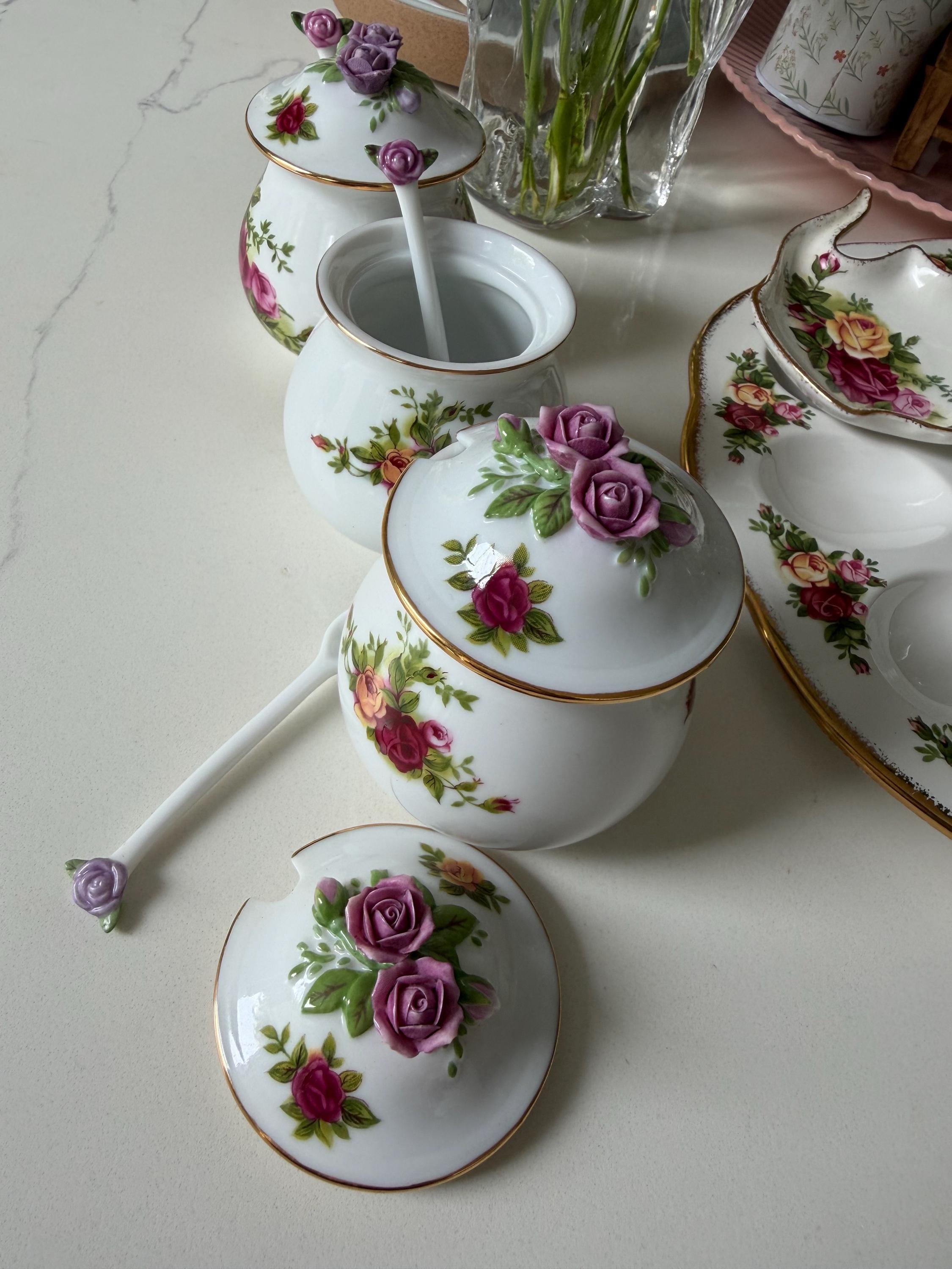 Porcelain sugar and salt jars with spoon, rose floral lids, and small stacked bases