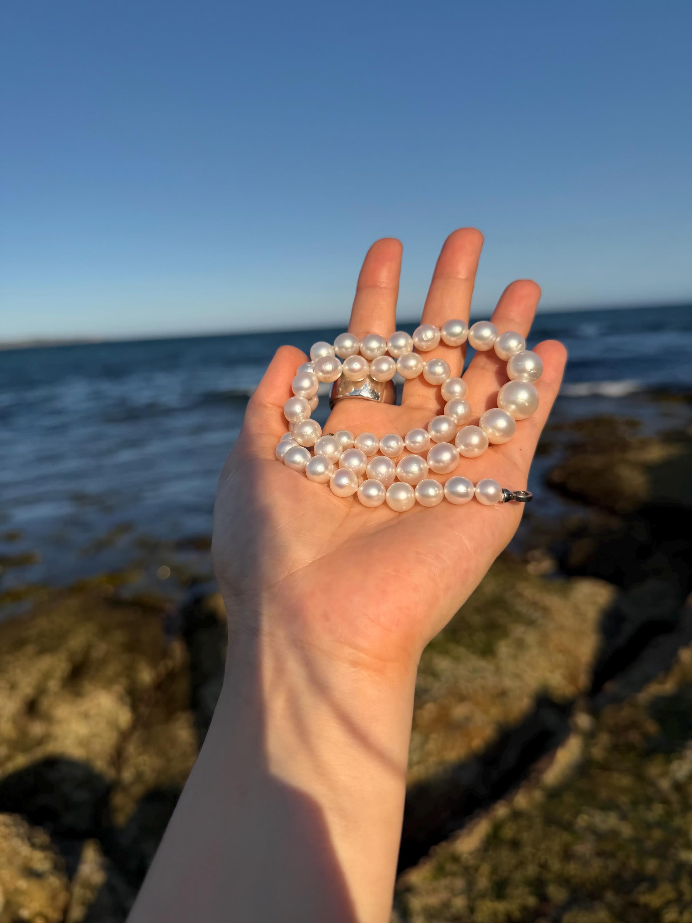 Multi-strand white pearl necklace with round pearls and silver-tone clasp