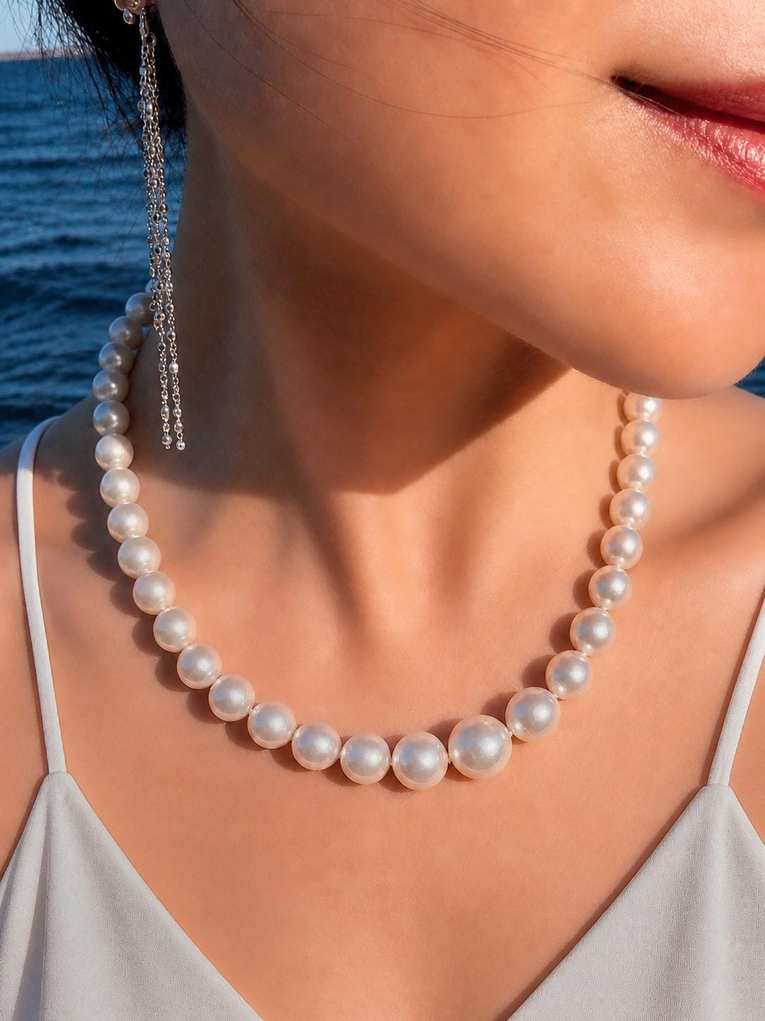 South Sea pearl necklace with evenly spaced round white pearls and a silver-toned chain