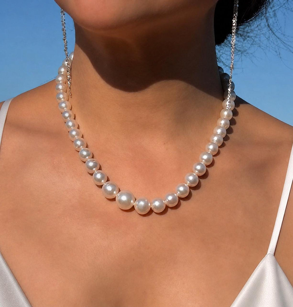 South Sea pearl necklace with round white pearls draping along the collarbone